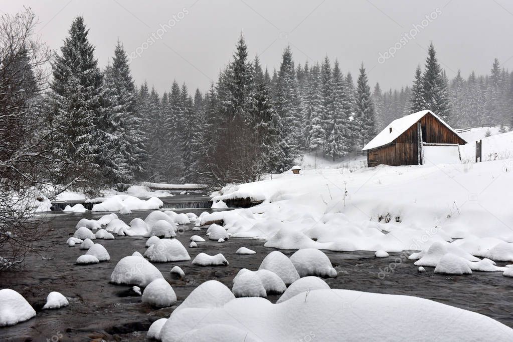 Mountain wooden chalet covered with fresh snow