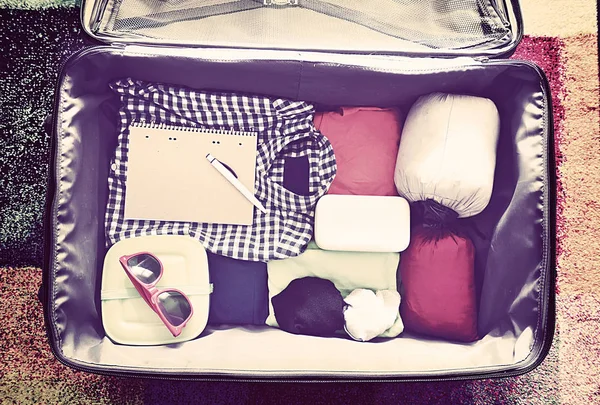 Travel accessories in a suitcase. Vintage toned — Stock Photo, Image