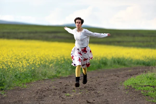 Young woman running on a countryside road