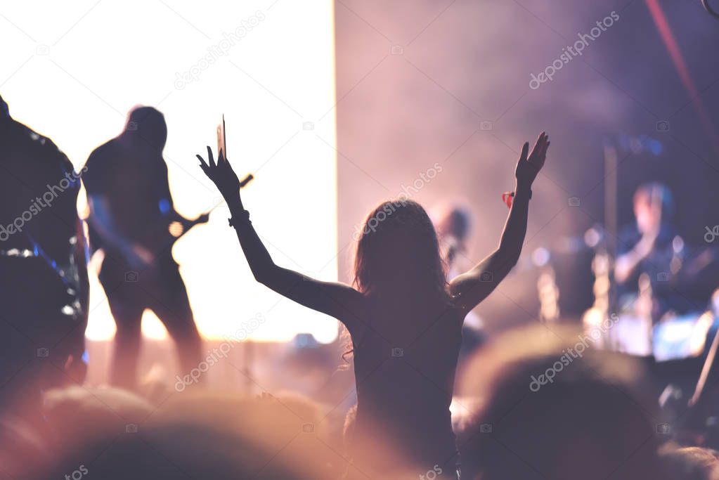 Rear view of a woman enjoying a concert