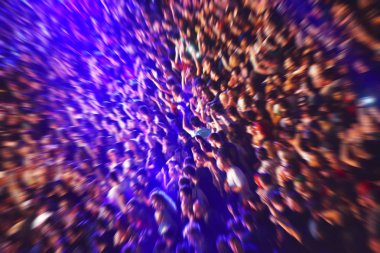 Blurred, defocused fans in a stadium at a concert clipart