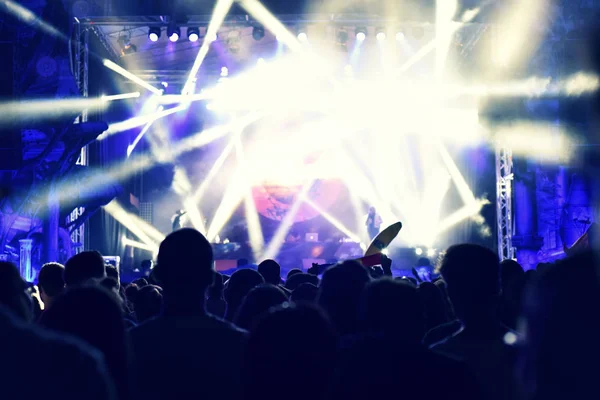 Crowd rocking during a concert with raised arms. — Stock Photo, Image