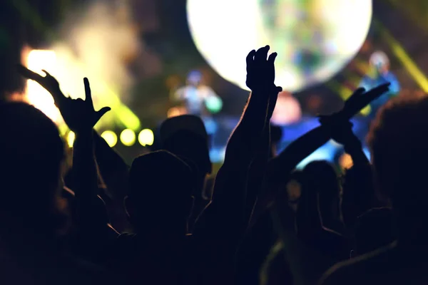 Crowd rocking during a concert with raised arms. — Stock Photo, Image