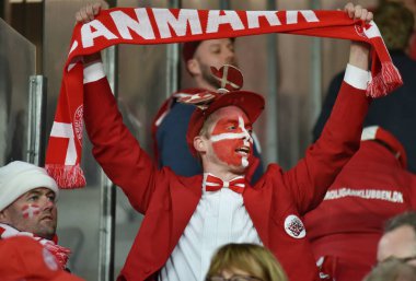 Cheering soccer fans of Denmark celebrating in tribune during a  clipart