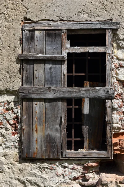 Old abandoned building wall with locked windows Stock Picture