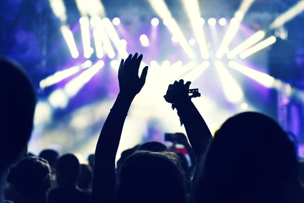 Crowd at a music concert, audience raising hands up — Stock Photo, Image