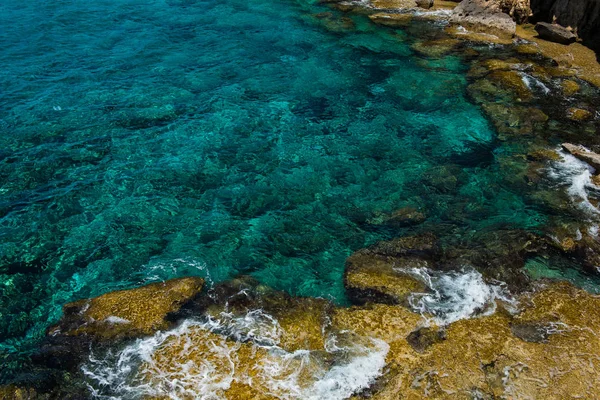 清澈的蓝绿色海水背景和岩石海岸 — 图库照片