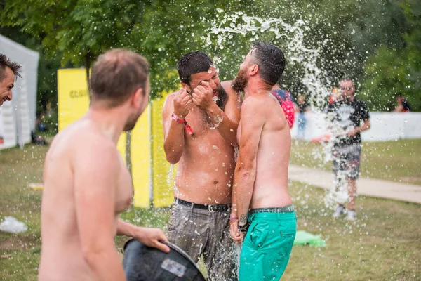 Guy spours vatten från en hink på huvudet vän — Stockfoto