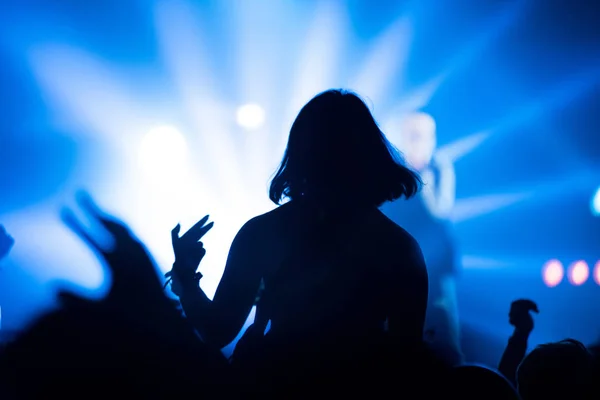 Silueta de la multitud de conciertos frente a las luces del escenario brillantes — Foto de Stock
