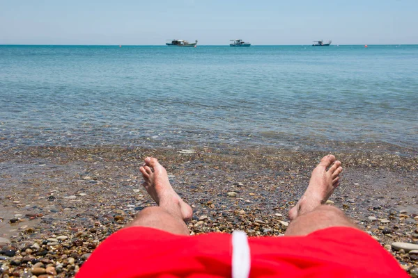 Havet vågor tvätt mannens fötter — Stockfoto