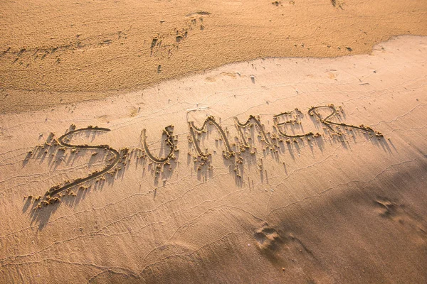 Summer word written in sand