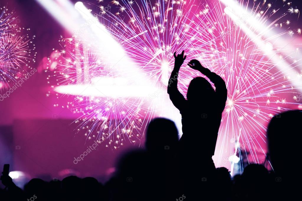 New Year concept. Cheering crowd and fireworks