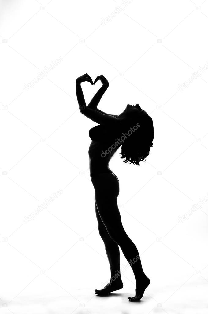 Silhouette of a sexy pole dancer isolated on white