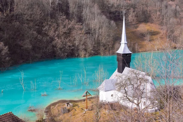 Catholic church and drowned cemetery. Waste lake with cyanide po — Stock Photo, Image