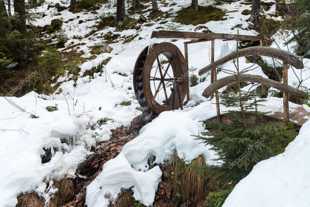 Functional small water mill wheel in the forest