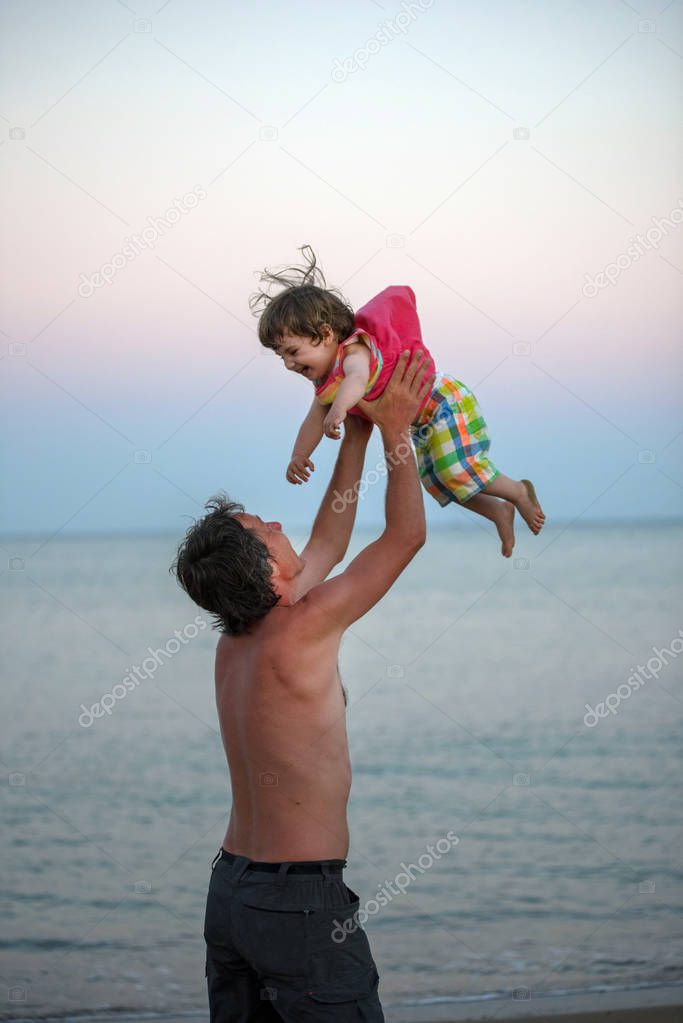 Father having fun with her daughter at sea