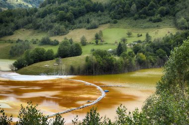 Pollution of a lake with contaminated water from a gold mine clipart