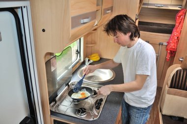 Aile tatil, karavan tatil gezi, seyahat ve kamp, adam camper, kamyonet ve karavan iç pişirme