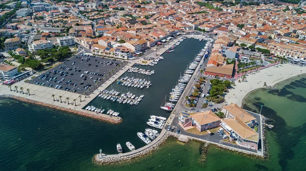 Aerial top view of boats and yachts in marina from above, harbor of Meze town, South France