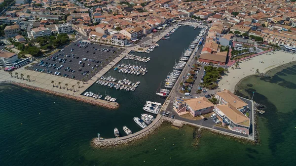 Aerial top view of boats and yachts in marina from above, harbor of Meze town, South France