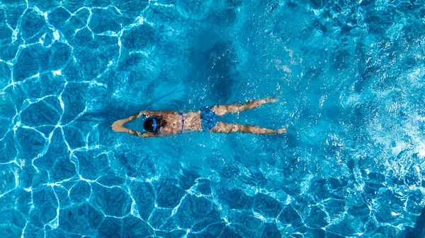 Aerial top view of woman in swimming pool water from above, tropical vacation holiday concept — Stock Photo, Image