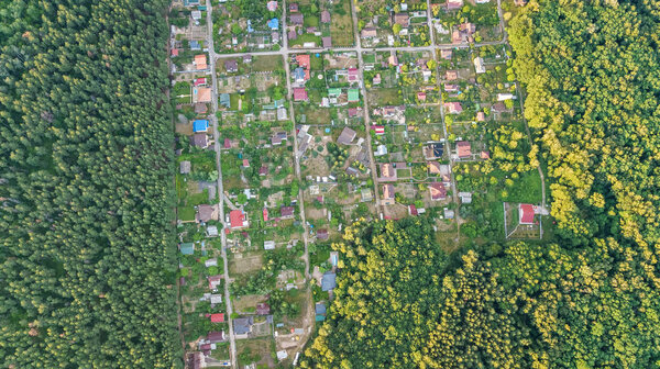 Aerial top view of residential area summer houses in forest from above, countryside real estate and small dacha village in Ukraine