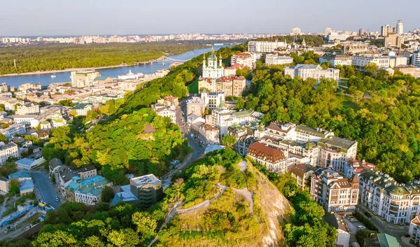 Aerial top view of Saint Andrew's church and Andreevska street from above, cityscape of Podol district on sunset, city of Kiev (Kyiv), Ukraine
