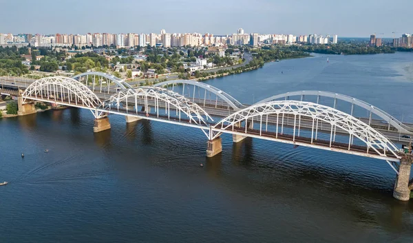 自動車・鉄道 Darnitsky 橋上から、キエフ市のスカイライン、ウクライナのドニエプル川の空中平面図 — ストック写真