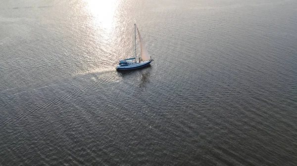 Aerial view of yacht sailing in Dnieper river on sunset from above — Stock Photo, Image