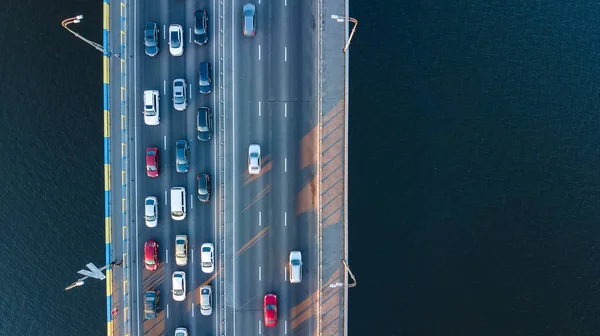 Aerial top view of bridge road automobile traffic jam of many cars from above, city transportation concept — Stock Photo, Image
