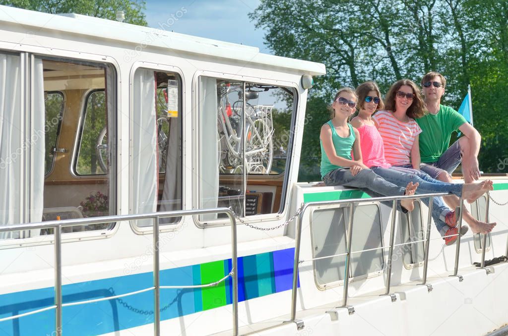 Family vacation, summer holiday travel on barge boat in canal, happy kids and parents having fun on river cruise trip in houseboat in France
