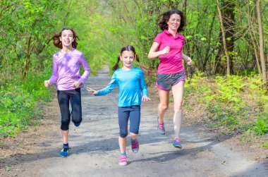 Aile sporu ve spor, mutlu aktif anne ve çocuklar dışarıda koşuyor, ormanda koşuyor, sağlıklı yaşam tarzı aile kavramı
