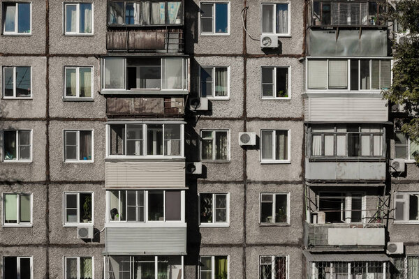 The wall of a dilapidated apartment building.