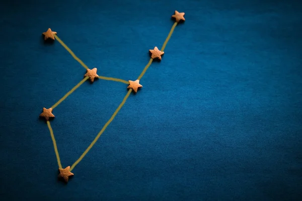 Gold stars on a blue background. Constellation Virgo, the sign of the zodiac. Prediction by date of birth. Daylighting, vignetting. The picture was made by the author.