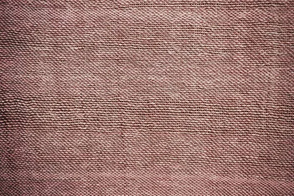 Rough pink fabric, canvas home production. Large threads, simple weaving. Muted tone, vignetting.