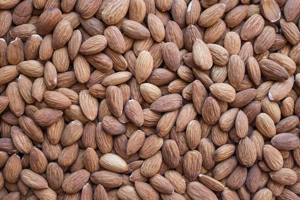 Brown almond grains, good harvest. Organic, healthy product, snack. Dietary menu, proper nutrition, health care. View from above.