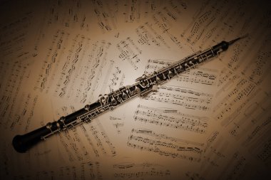 Oboe with music sheet notes clipart