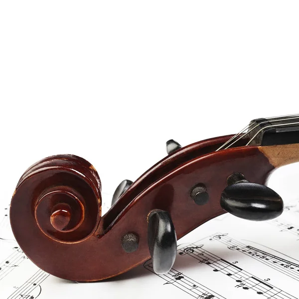 Violin scroll with music sheet notes — Stock Photo, Image