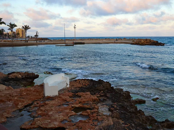 Bench made of stone in beautiful Torrevieja beach, Costa Blanca, — Stock Photo, Image