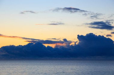 Bright cumulus clouds against the blue sky. Sunset sky Natural background. seascape