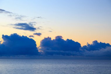 Bright cumulus clouds against the blue sky. Sunset sky Natural background. seascape