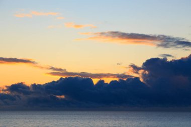 Bright cumulus clouds against the blue sky. Sunset sky Natural background. seascape