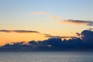 Bright cumulus clouds against the blue sky. Sunset sky Natural background. seascape