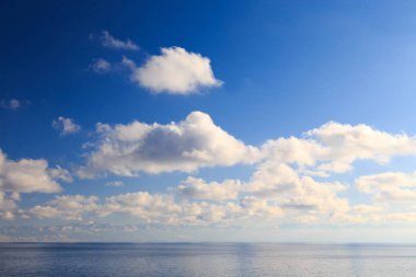 Bright cumulus clouds against the blue sky. Sunset sky Natural background. seascape