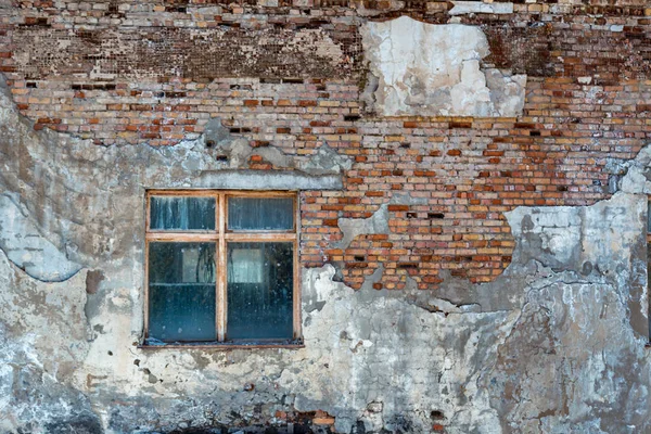 Texture of an old building with a window. Background ruined plaster