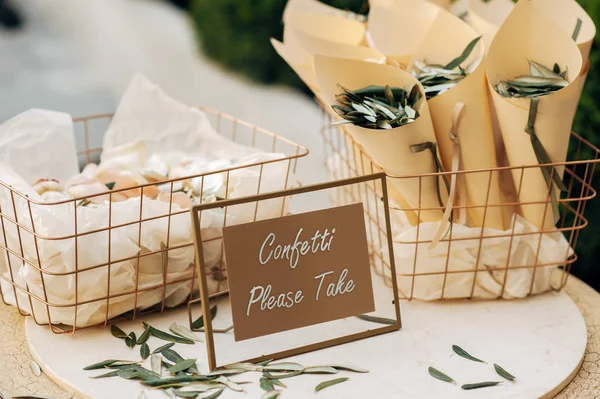 Basket with confetti and eucalyptus, wooden board with inscription stands on table — Stock Photo, Image