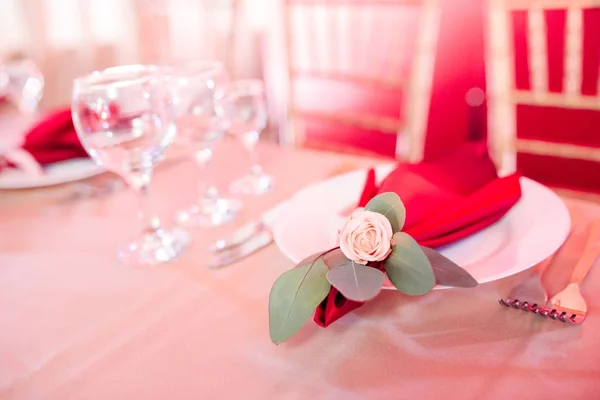 Détails sur le décor de table - petite rose dans le coin de la serviette bordeaux sur une assiette — Photo