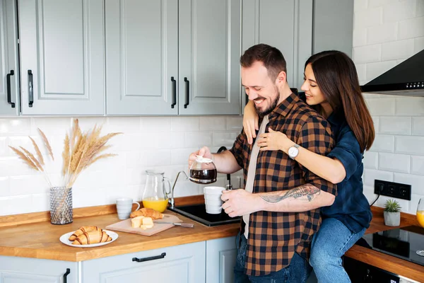 Coppia amorevole in una elegante cucina grigia — Foto Stock