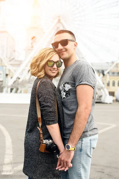 Loving couple with sight wheel on background — Stock Photo, Image