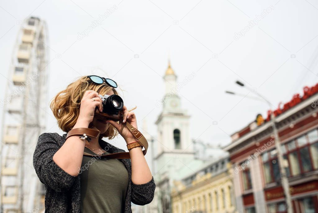 A tourist girl with a camera sightseeings